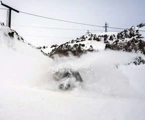 Freerider snowboarder moving down in snow powder