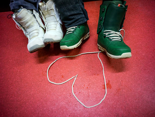Symbol of heart from lace snowboard boot, made in love couple after riding in the mountains