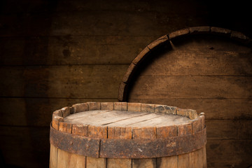 Old wooden barrel on a brown background