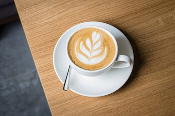 Closeup coffee in cup on the table,warm tone