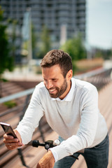 Young businessman outdoors. Young businessman outdoors. Handsome businessman driving electric scooter while using phone.