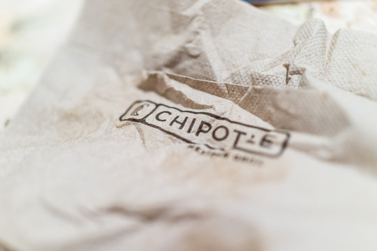 Brown crinkled napkin with Chipotle sign word