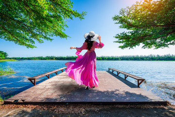 Young tourist stands on Nong Han Pier. Near the lotus garden in Sakon Nakhon Province,Thailand.