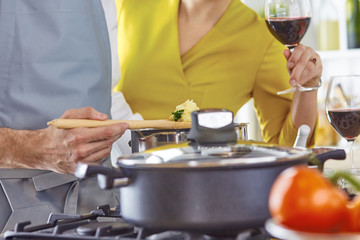 Smiling young couple cooking food in the kitchen