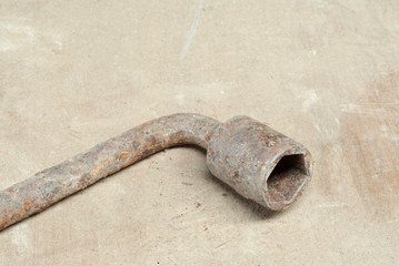 Old wrench on a wooden background. Oldie concept