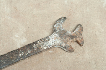 Old wrench on a wooden background. Oldie concept