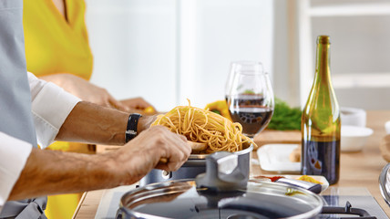 Smiling young couple cooking food in the kitchen