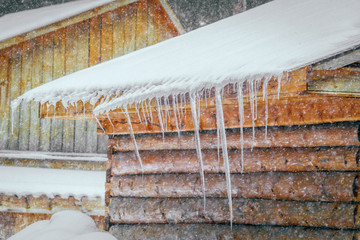 ice from the roof of the house in winter