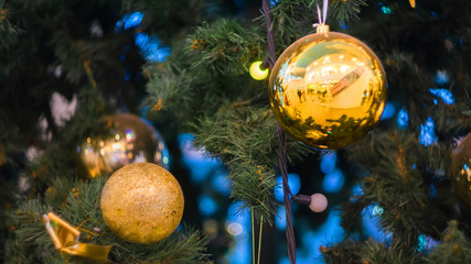 Christmas yellow balls on Christmas tree background