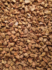 Ground coffee in granules. The texture of the freshly ground coffee granules