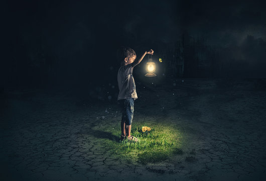 Lost child holding an old lamp in an apocalyptic environment
