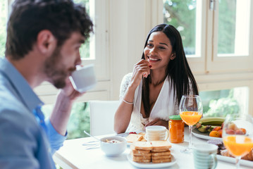Obraz na płótnie Canvas Couple in love eating breakfast in the morning