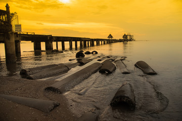 Chon Burii, Thailand - October, 06, 2019 :  Landscape of old bridge in the sea at sunset time...