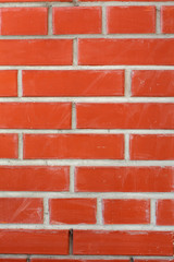 Brick wall or background. Decorative orange bricks. Construction and design. Stained surface. Close up