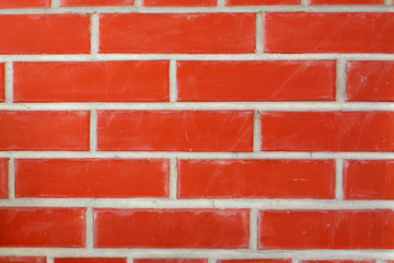 Brick wall or background. Decorative orange bricks. Construction, architecture and design, cladding of building facades. Stained brick surface. Close up