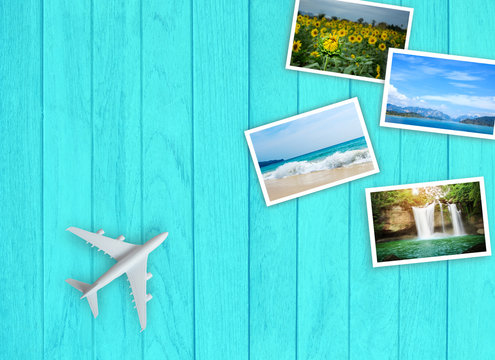 White miniature toy plane on a Light blue wooden table background and Travel image. The concept is going to travel on a passenger plane.