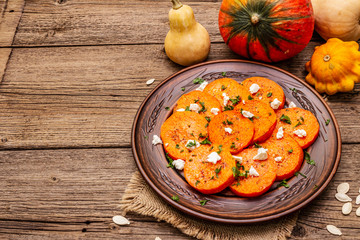 Roasted pumpkin with salted cheese and herbs