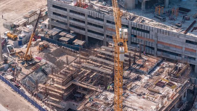 Aerial view of construction with special machines engeneers and huge cranes in Business Bay, Dubai, United Arab Emirates Timelapse