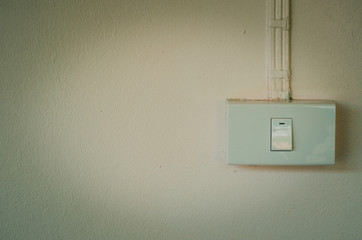 Electric switch on the wall in vintage tone