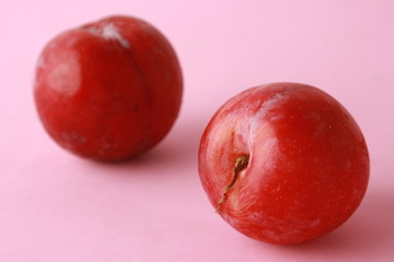 Delicious plums in colorful background