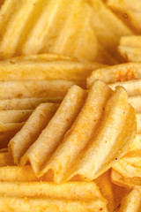slices of fried potato shaped chips, beautiful background for layout or text. vertical, close-up