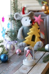  Toy rat in a Santa hat, Christmas decor, spruce branches, frames, illumination against a window...