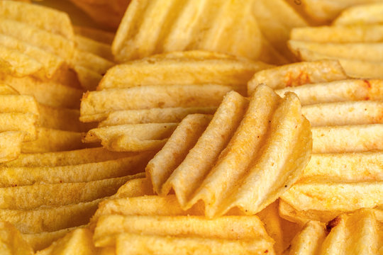 slices of fried potato curly chips, beautiful background for layout or text