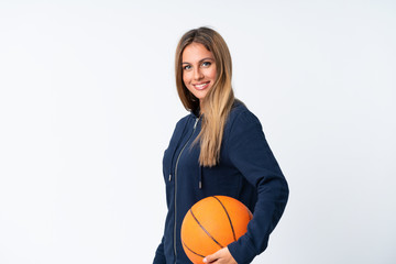 Young woman playing basketball over isolated white background