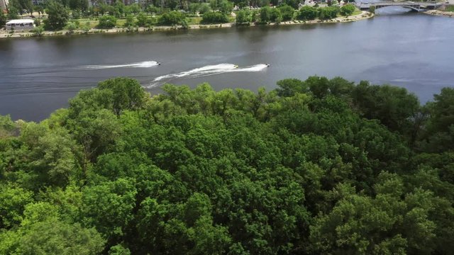 Aerial top view of riding on a water bike jet-ski. Jet ski on the surface of the river. People are playing a jetski. 4K video.