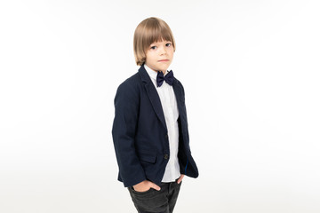 Picture os a teenager boy in black suit stands and pose isolated on white background