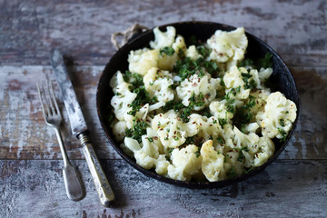 Cauliflower with spices baked in a pan. Vegan food.