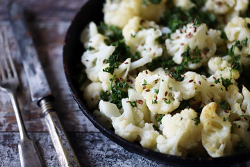 Cauliflower with spices baked in a pan. Vegan food.