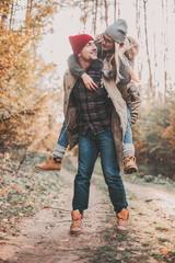 Traveler couple in love so fun in the forest. Concept of trekking, adventure and seasonal vacation.