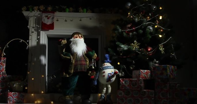 Santa clause standing in specially decorated room, looking at camera and smiling