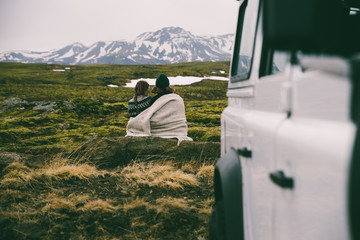 Couple making a wanderlust vacation, exploring iceland with their 4x4 jeep
