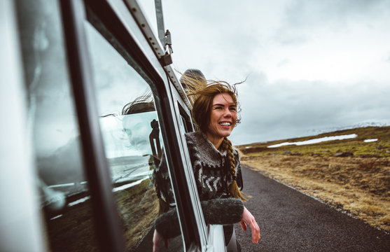 Beautiful icelandic girl enjoying the landscape in Iceland ,looking out the car window
