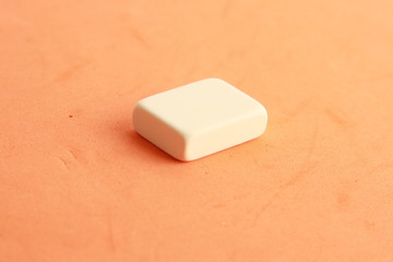 white eraser on color background