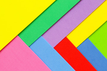 An abstract geometric textured background of multicolored rainbow colors created with overlapping foam craft paper 
