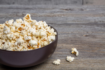 Fresh popcorn in a bowl on a rustic table