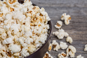 Fresh popcorn in a bowl on a rustic table