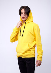 photo of man wearing yellow hoodie isolated on white background.