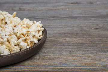 Fresh popcorn in a bowl on a rustic table