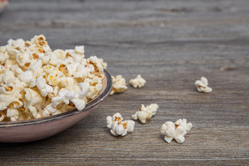 Fresh popcorn in a bowl on a rustic table