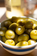 Homemade pickled green olives stuffed  with garlic in bowl, spanish tapas