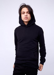 photo of man wearing black hoodie isolated on white background.