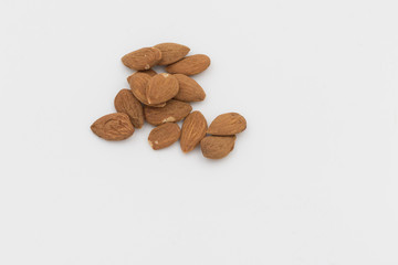 group of shelled almonds on a white background