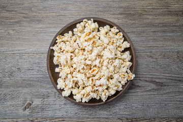 Fresh popcorn in a bowl on a rustic table