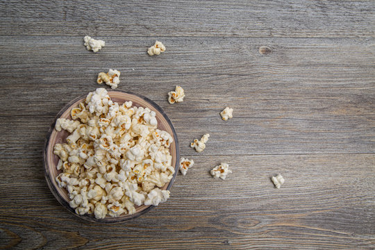 Fresh popcorn in a bowl on a rustic table