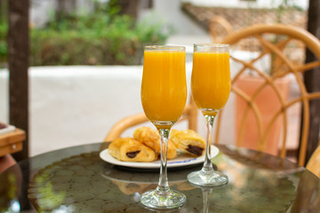 Healthy breakfast with two glasses of freshly squeezed orange juice