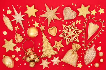 Gold Christmas bauble decorations on red background. Traditional greetings card for the festive season.